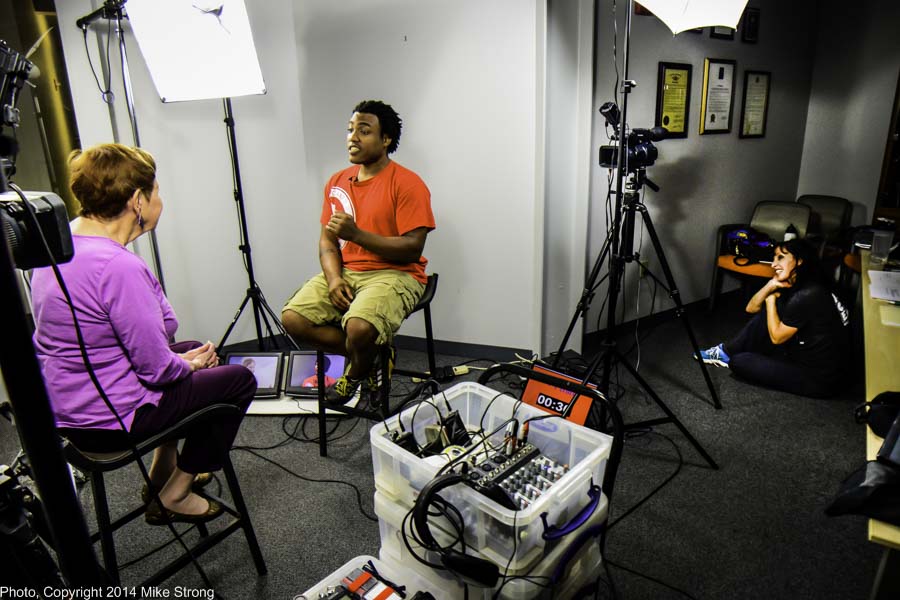 Billie interviewing Ronald Harvey (capoeira) with wife Sonia sitting on the floor to the right